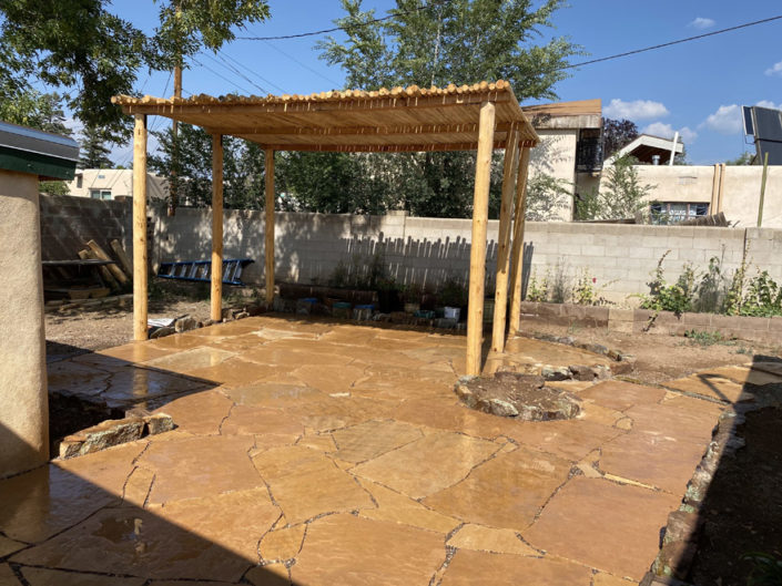 flagstone patio and rustic shade structure