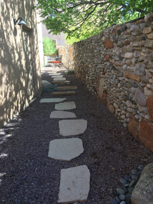 Staggered stepping stone pathway leads to patios